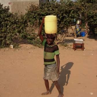 Ngombe street scene: water carrier